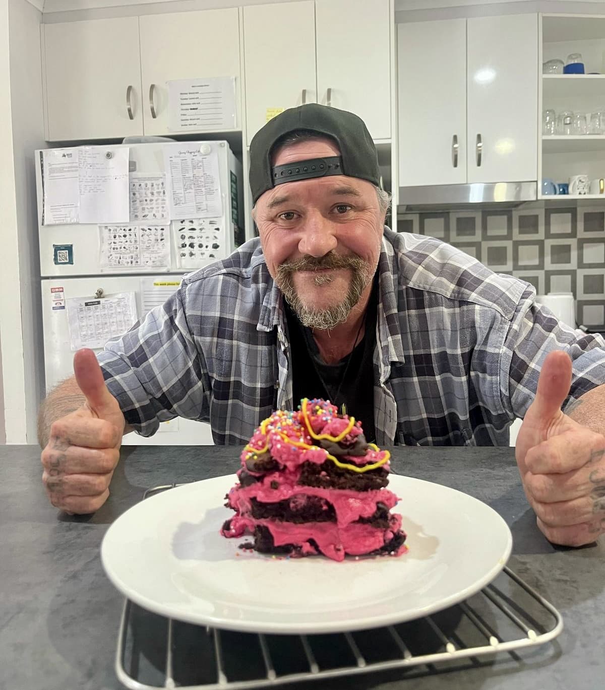 Participant proudly showing off homemade pancakes