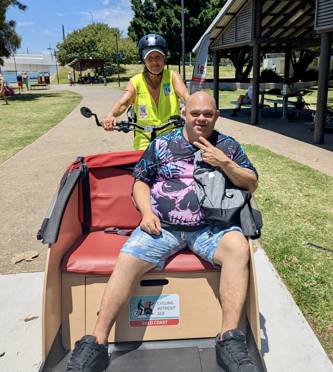 Acts Care participant enjoying a trishaw bike ride with support worker
