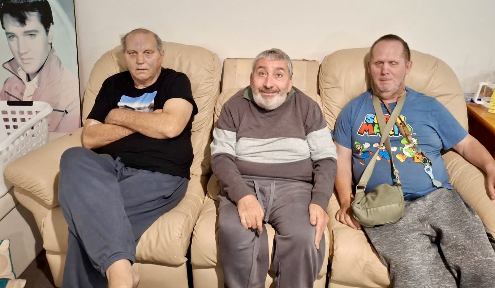 Three participants relaxing together in their supported living home