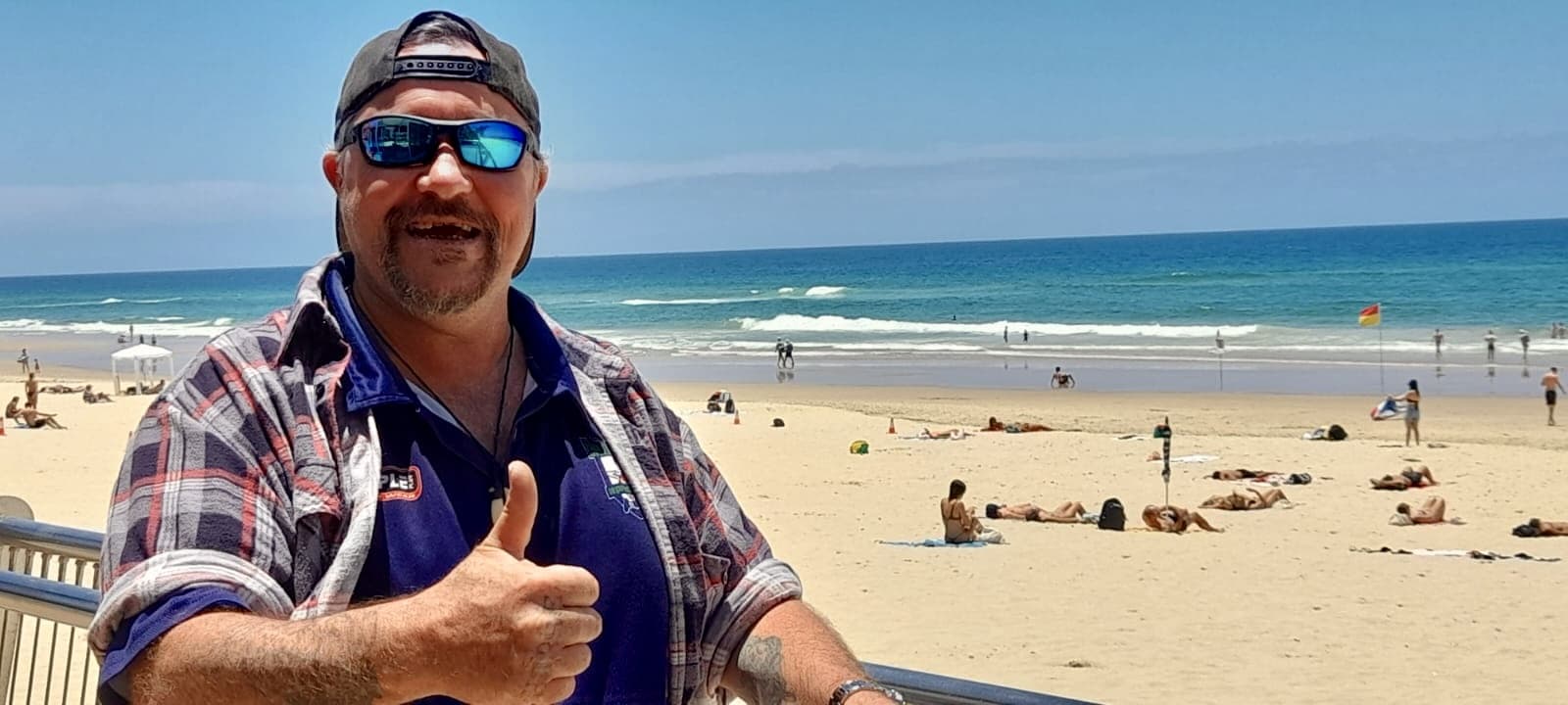 Acts Care participant enjoying a day out at the beach