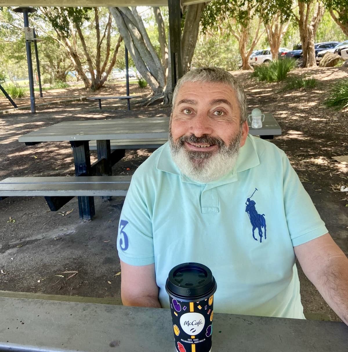 Acts Care participant enjoying coffee at the park
